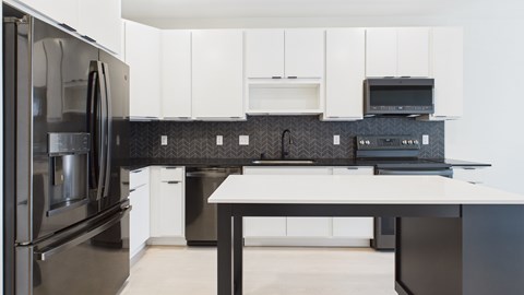 A modern kitchen with a black and white color scheme.