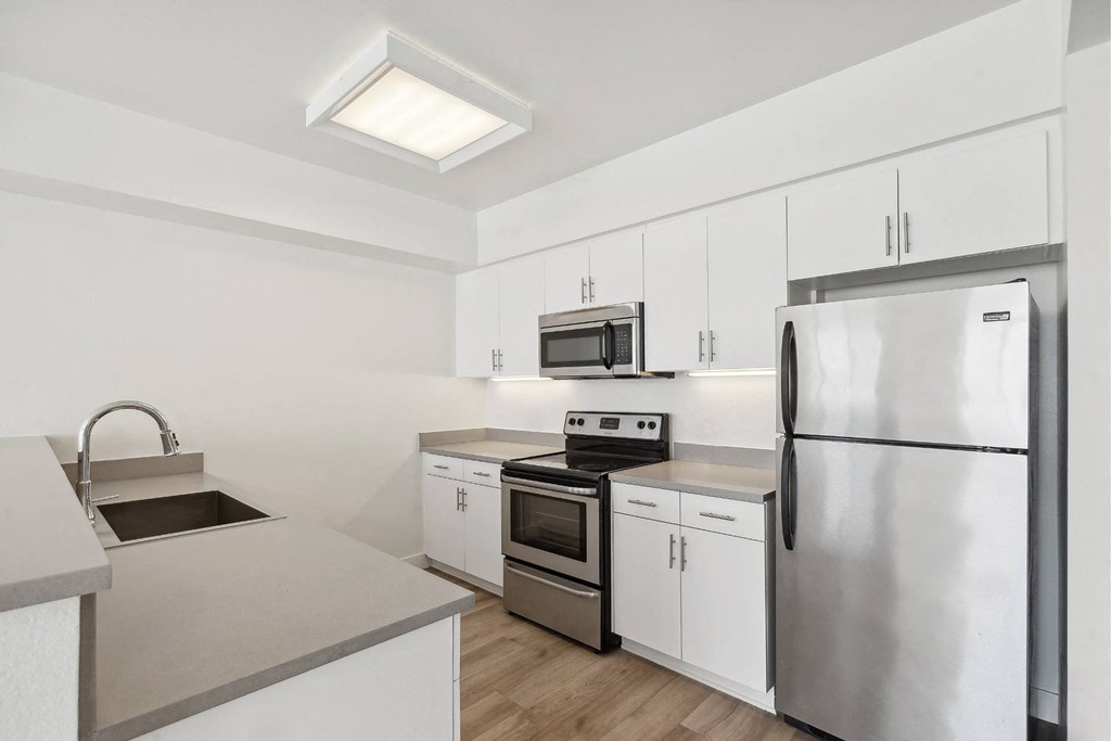 luxury kitchen with custom cabinets and stainless steel appliances at One Santa Fe luxury apartments