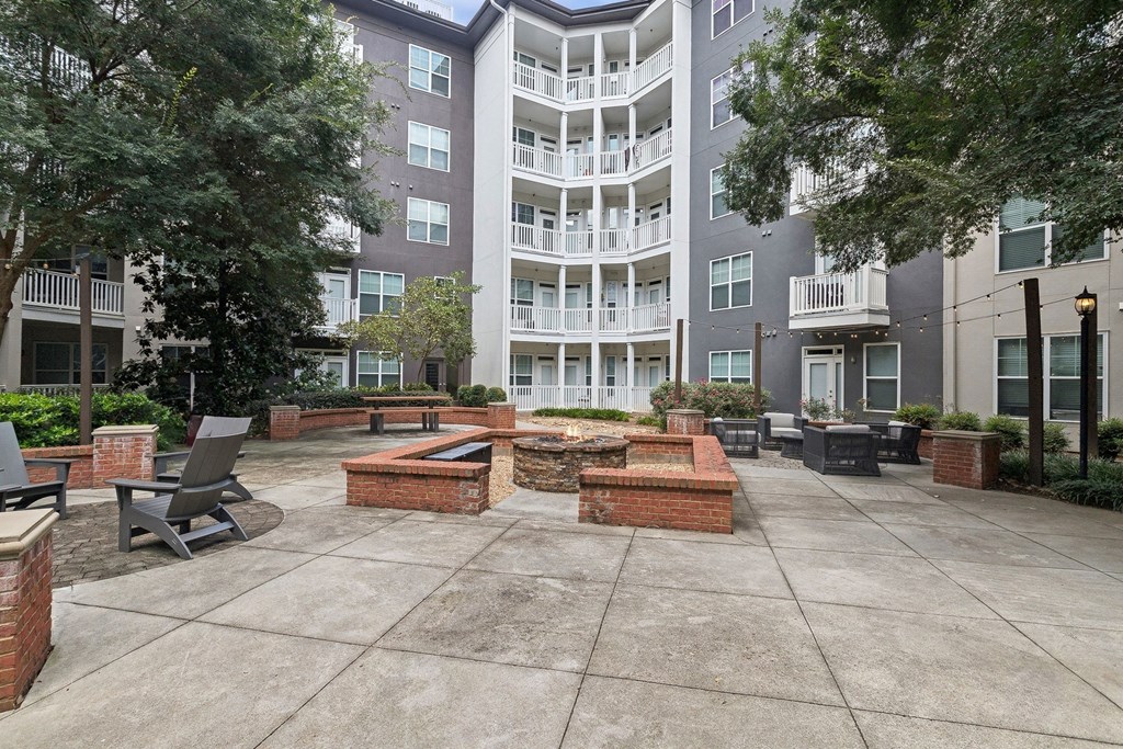 outdoor fireside lounging area with comfortable seating at Sorelle apartments