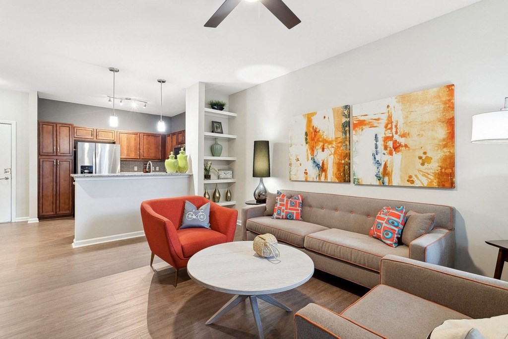 spacious kitchen and living room with wood-inspired flooring at Sorelle apartments