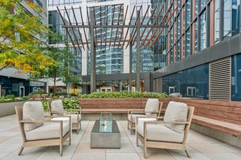 outdoor fireside lounging area with comfortable seating at Via Seaport apartments in Boston