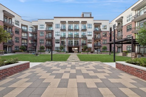 A large building with a checkerboard patterned walkway in front.