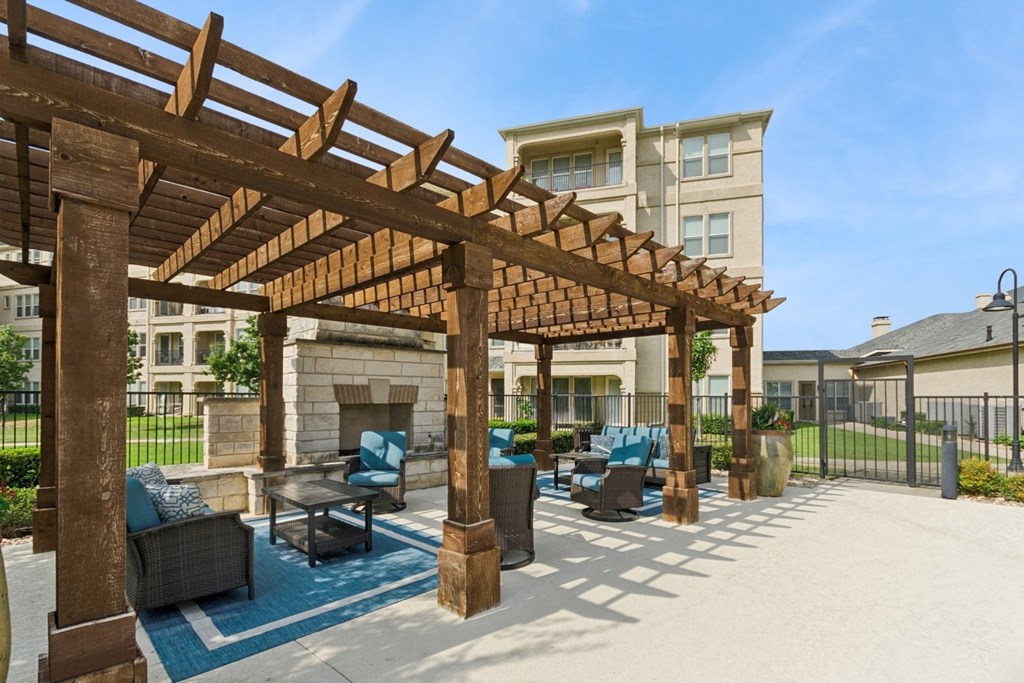 outdoor pergola patio with fireside lounging area at Retreat at Wylie senior 55+ apartments