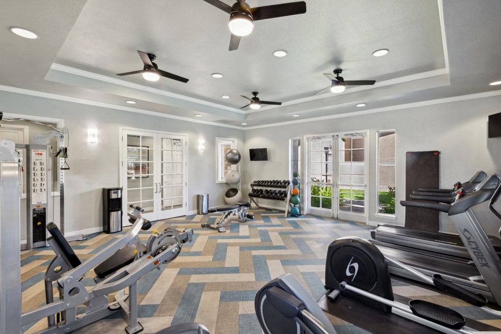 fitness center with cardio equipment and free weights at Bridgeport Ranch apartments