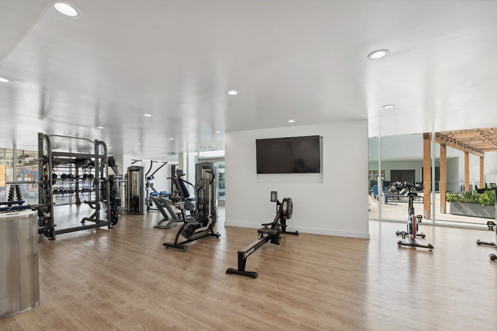 fitness center with strength training equipment at One Santa Fe apartments
