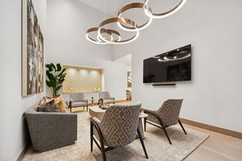 social lounge with comfortable seating and conversation areas at Via Seaport apartments