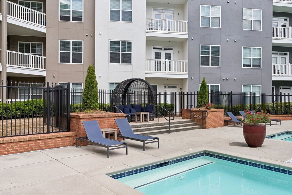 swimming pool with sundeck lounging areas at Sorelle apartments