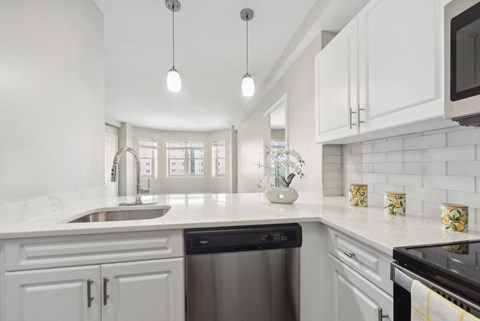 kitchen with designer pendant lighting and custom cabinetry at HighPoint luxury apartments