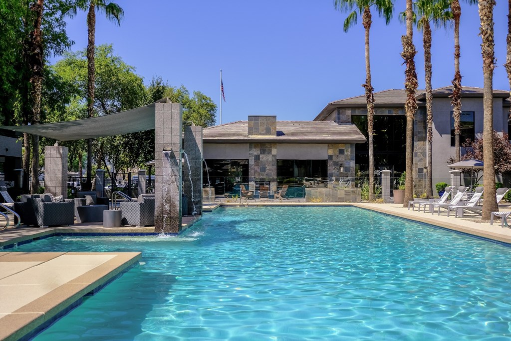 swimming pool with resort-inspired lounge seating at Avora luxury apartments