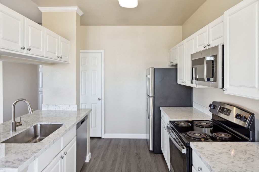 spacious kitchen with white cabinets and stainless steel appliances at Bridgeport Ranch apartments