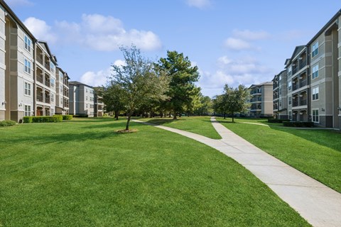 exterior view with walking paths at Park at Magnolia apartments