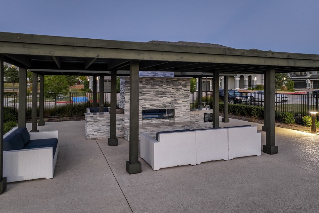 outdoor fireside lounging area with comfortable seating at Reveal on the Lake apartments