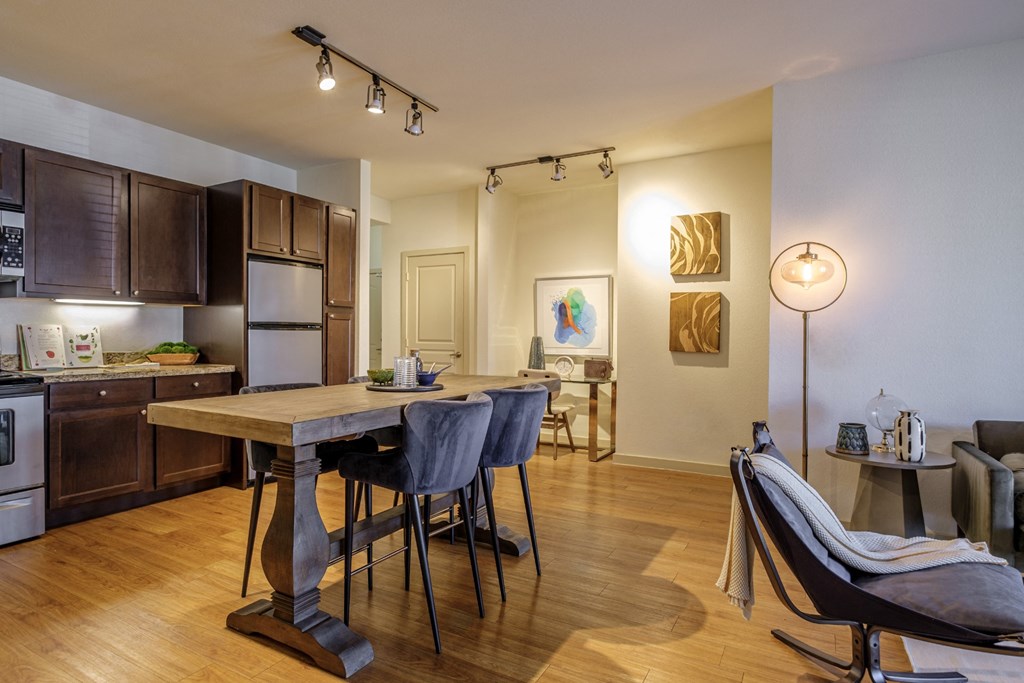 spacious open concept kitchen and living area with hardwood inspired flooring at The Pradera apartments