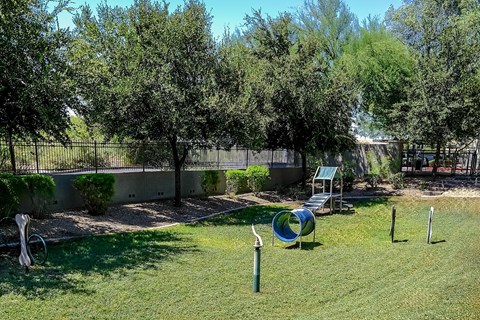 A playground with a slide and a green slide.