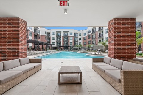 A pool area with a red exit sign above it.