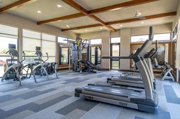 fitness center with cardio equipment at The Pradera apartments