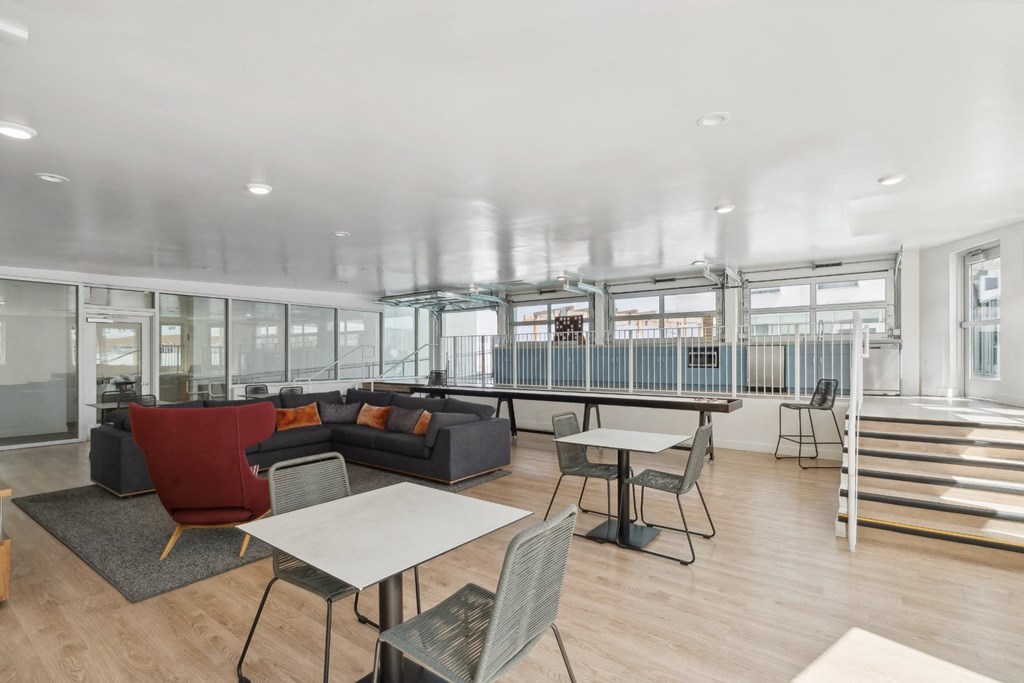 social lounge with comfortable seating, conversation areas and gaming area at One Santa Fe apartments