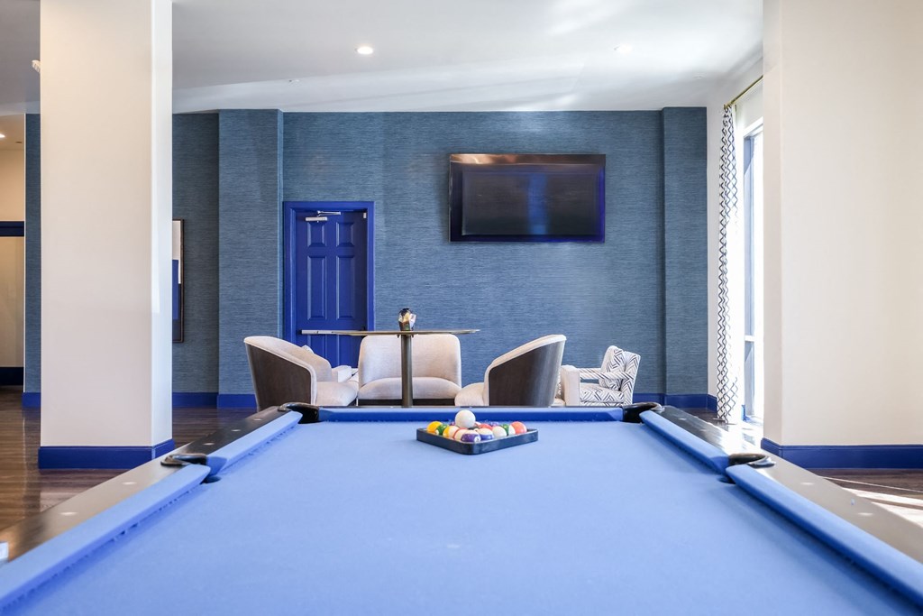social area with billiards at Reveal on the Lake apartments