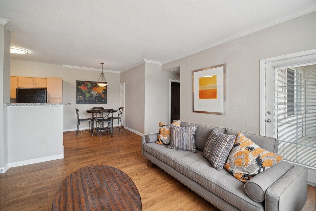 living room with wood-inspired flooring at Red Hawk Ranch apartments