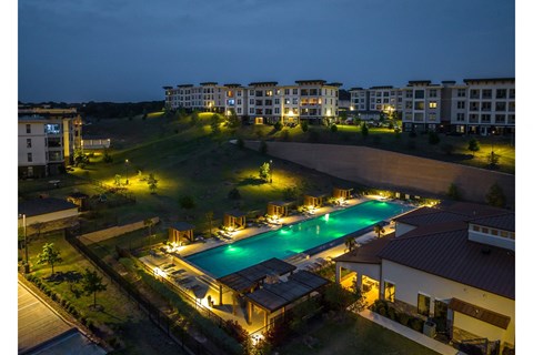 evening view of the resort-inspired swimming pool at Reveal Skyline apartments