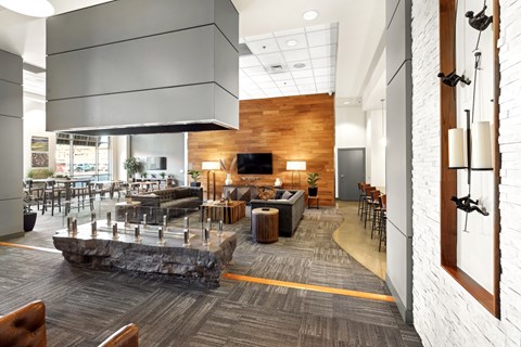 A modern office space with a stone feature in the middle of the room.