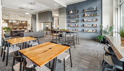 A modern dining area with wooden tables and chairs.