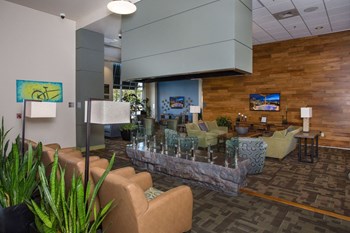 Amenities-Leasing Office and Clubhouse with White Armchairs on Area Rug with Coffee Tables Leasing Office and Clubhouse with White Armchairs on Area Rug with Coffee Tables at 2020 Lawrence, Colorado, 80205 - Photo Gallery 6