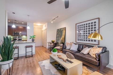 a living room and kitchen with a couch and a table