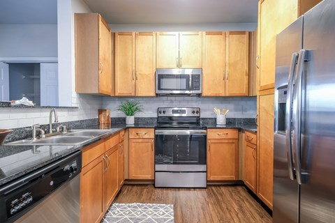a kitchen with stainless steel appliances and wooden cabinets