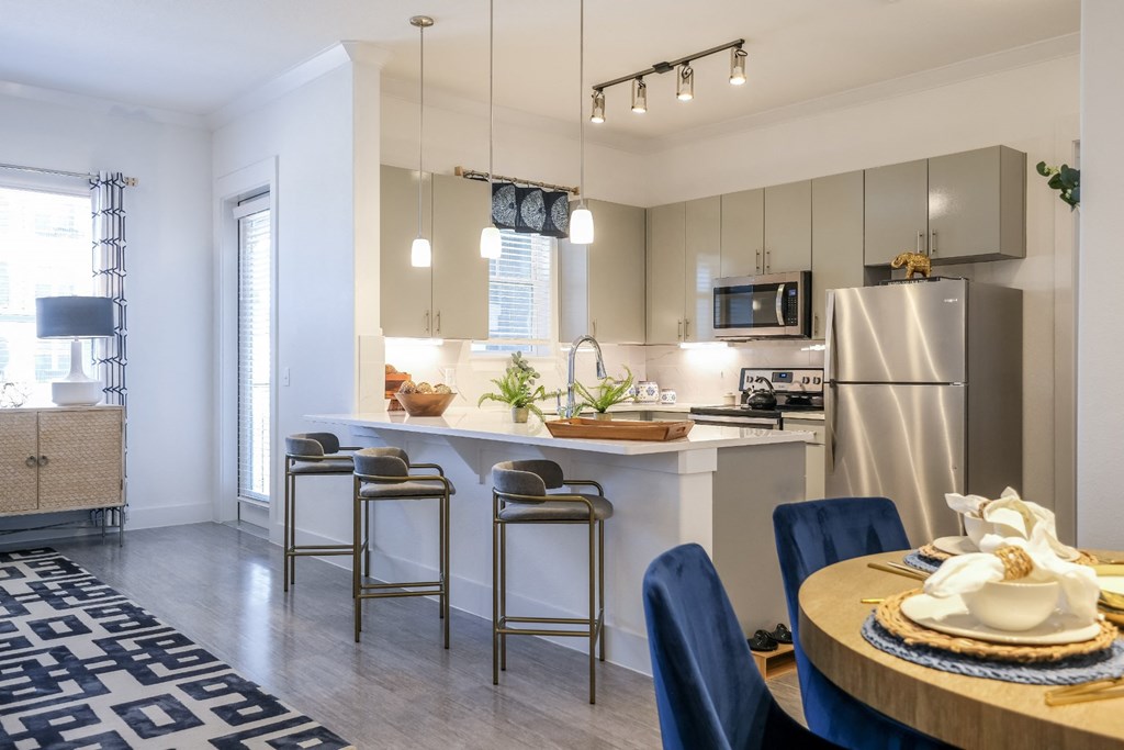 luxury kitchen and open-concept living area at Reveal on the Lake apartments