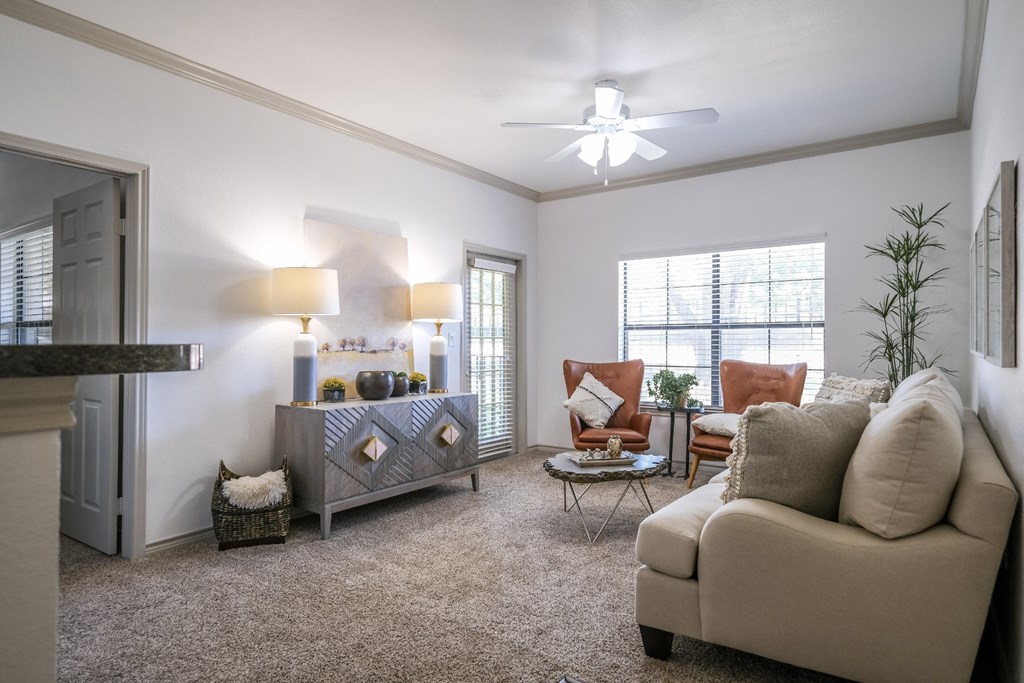 spacious living room with expansive windows at Stoneleigh on Spring Creek apartments