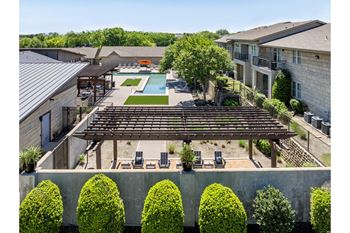 swimming pool and poolside lounging area at The Pradera apartments