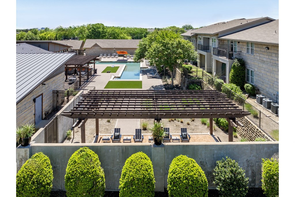 swimming pool and poolside lounging area at The Pradera apartments