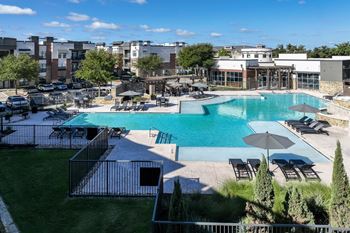 swimming pool with sun deck at Soho Parkway apartments