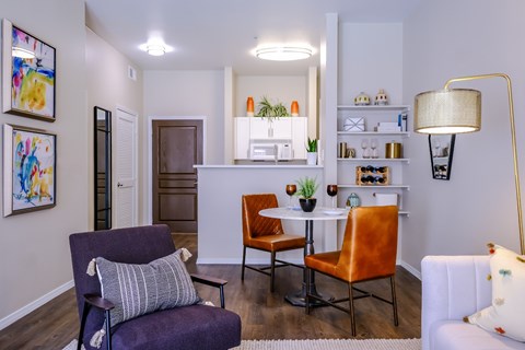 A living room with a purple chair and a white couch.