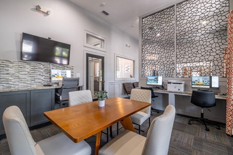 a business center with computers at Verano apartments