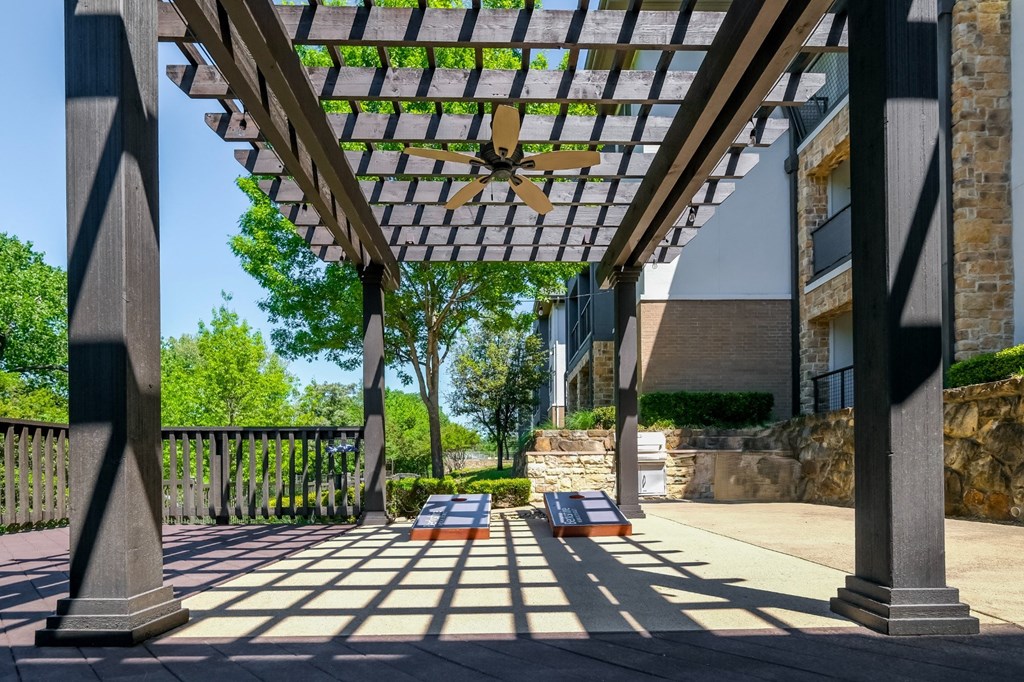 outdoor pergola social area with cornhole at Berkshire Medical District apartments