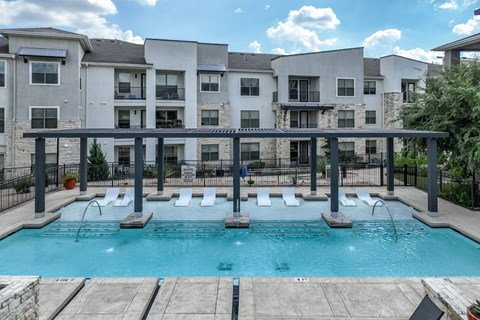 swimming pool with aqua tanning ledge at The Allure apartments