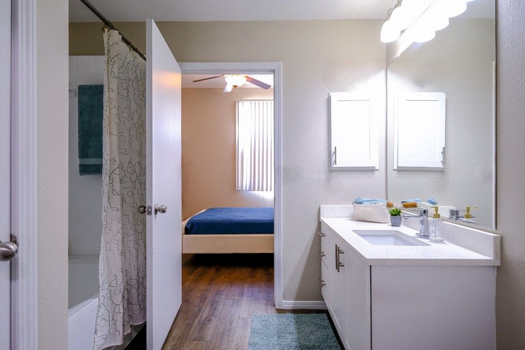 luxury bathroom with modern white cabinetry at Roosevelt Square apartments