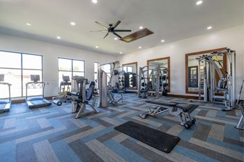 fitness center with cardio and strength training equipment at The Pradera apartments