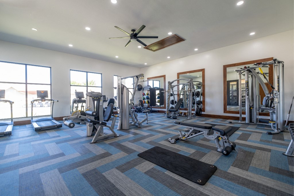 fitness center with cardio and strength training equipment at The Pradera apartments