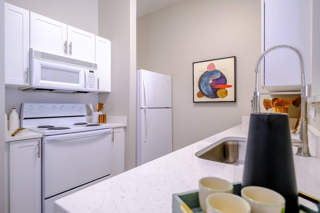 well appointed kitchen with modern white cabinetry at Roosevelt Square apartments in Phoenix