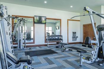 fitness center with free weights at The Pradera apartments