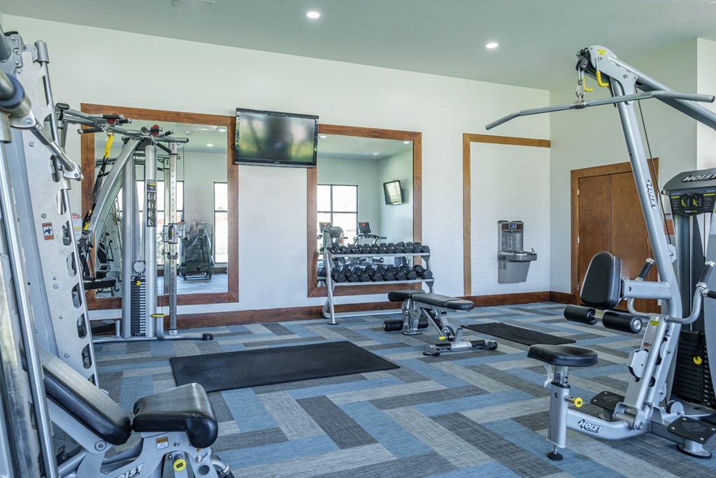 fitness center with free weights at The Pradera apartments