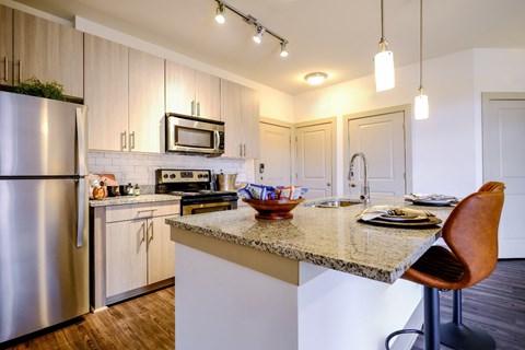 a kitchen with stainless steel appliances and a granite counter top