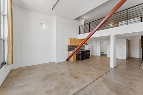 A room with a staircase and a table.