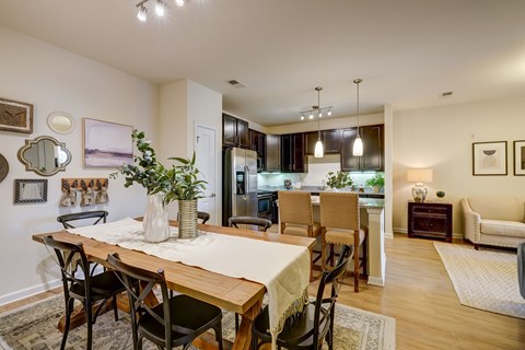 A dining room with a wooden table and chairs.