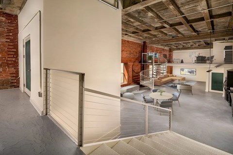A room with a brick wall and a white door.