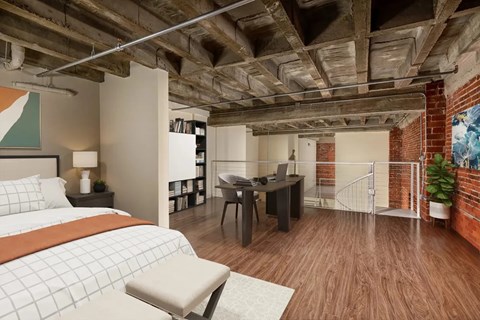 A bedroom with a bed, desk, and chair.