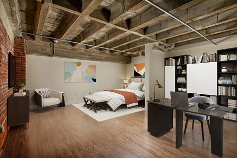 A room with a bed, desk, and chair.